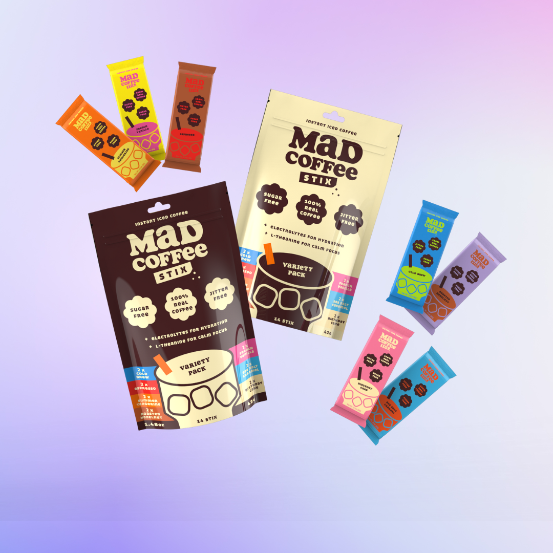 Assorted Mad Coffee Stix packages on a gradient background.
