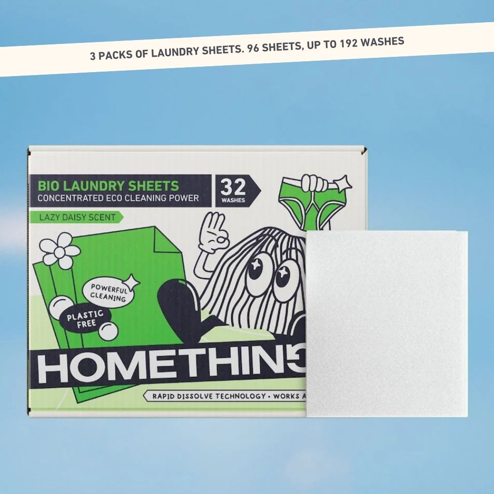 Hand inserting tablet into bottle, surrounded by cleaning supplies and vase of flowers.