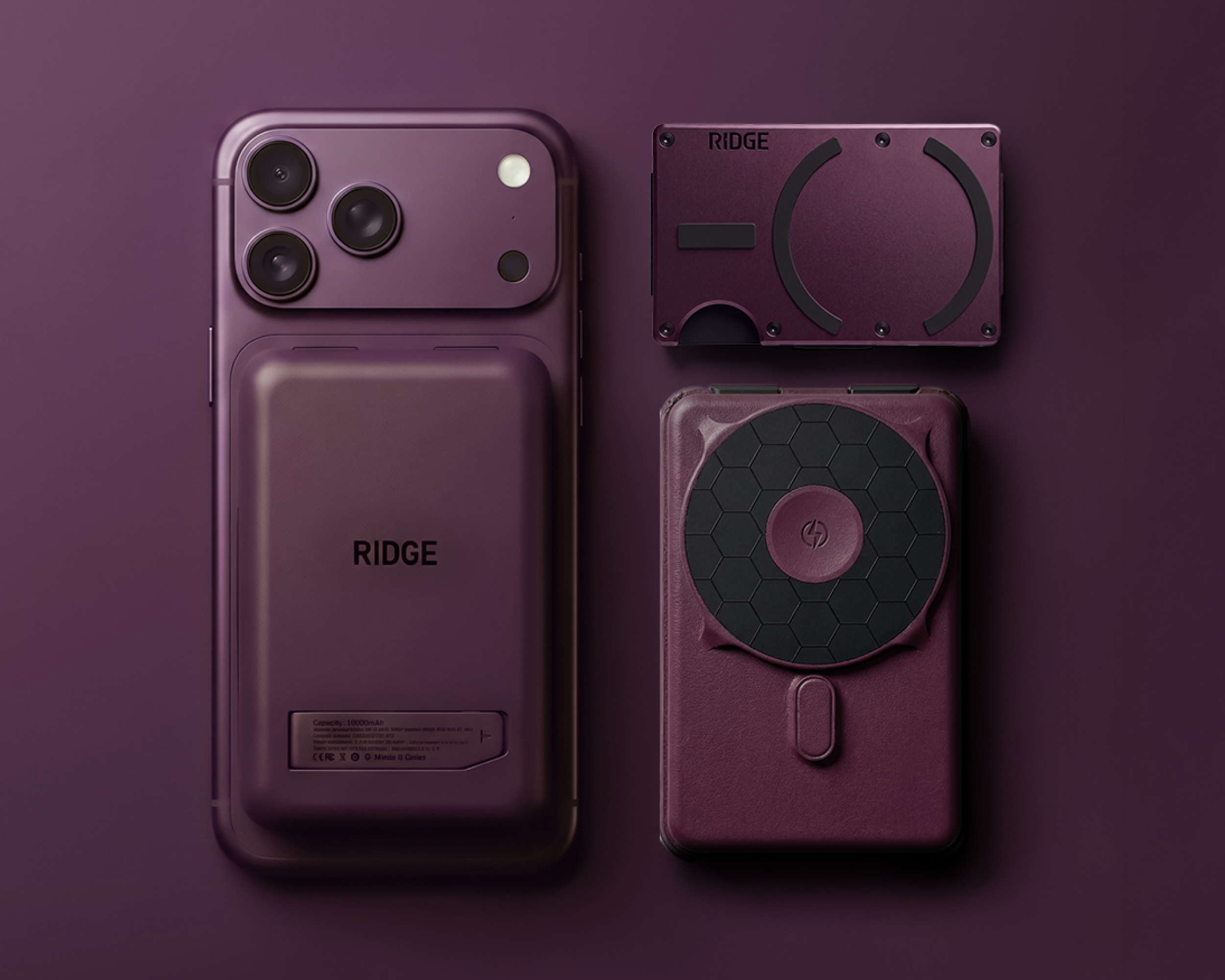 A purple smartphone with a battery pack, a minimalist wallet, and a portable charger on a purple background.
