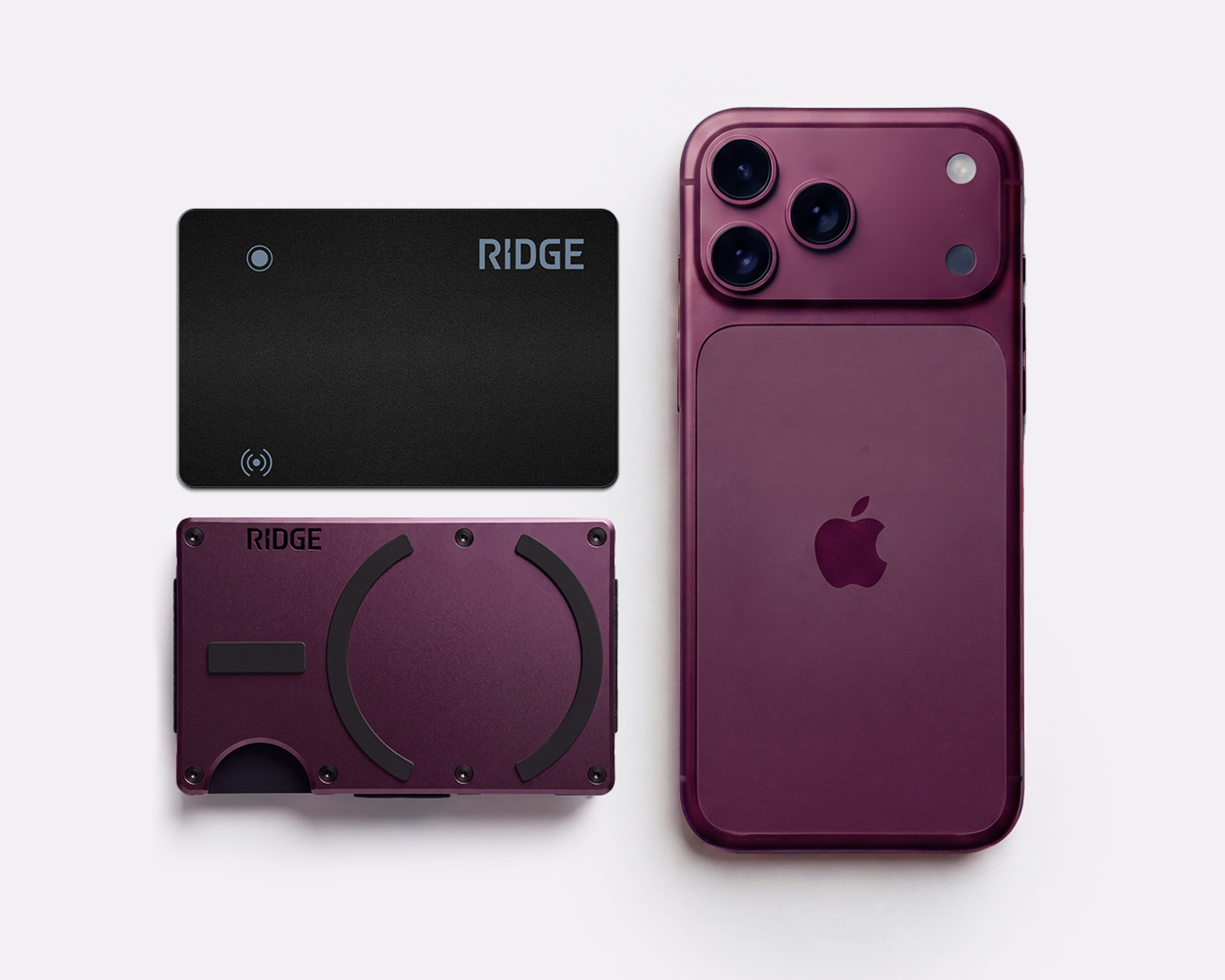 A purple iPhone with a matching purple Ridge wallet and a black card on a white background.