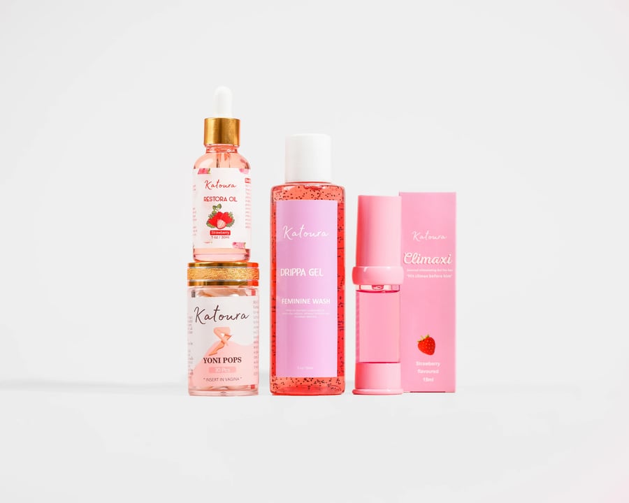 The full collection of Katoura pink-packaged intimate-care products lined up.
