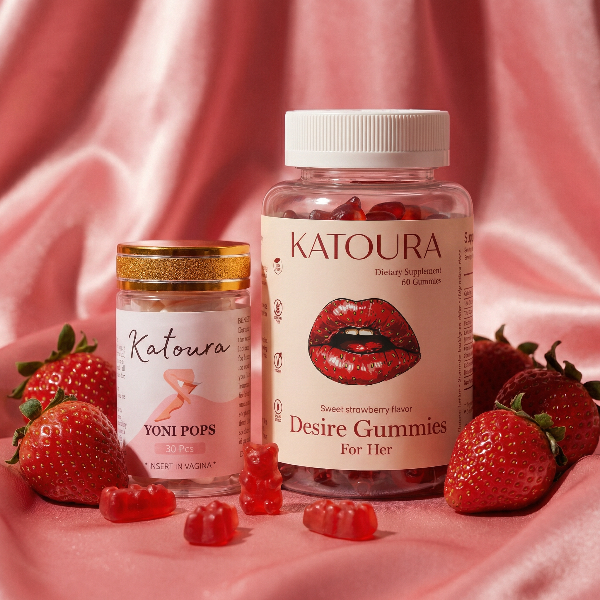 Two bottles of Katoura brand supplements, surrounded by fresh strawberries and gummy bears on pink satin fabric.