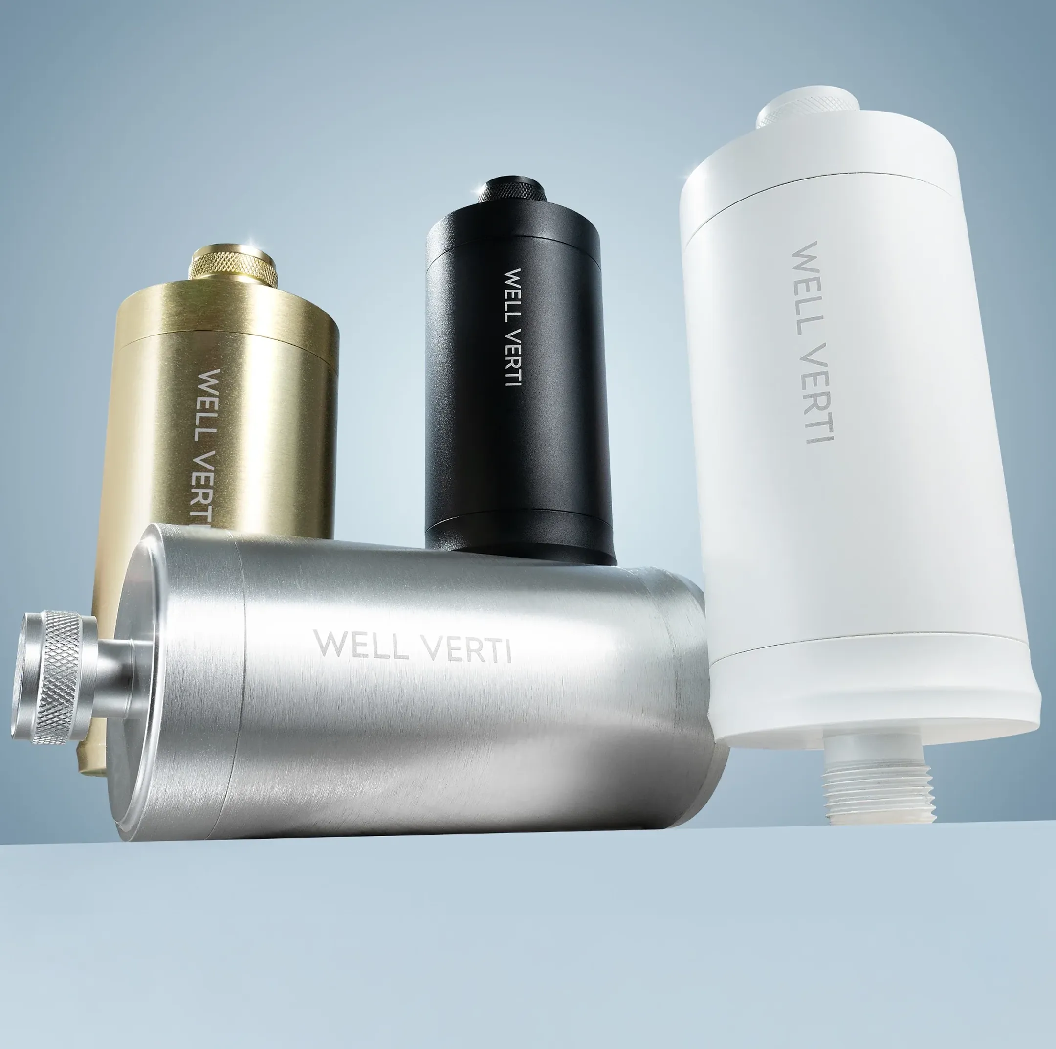 Four WELL VERTI water filters in silver, gold, black, and white arranged against a blue background.