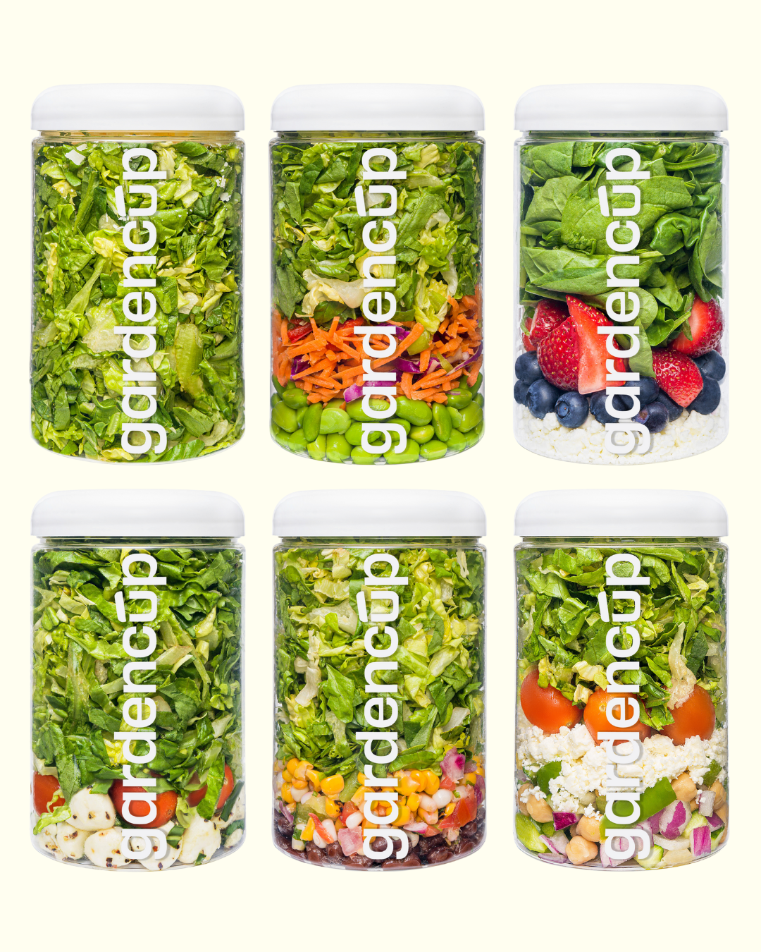 Six jars filled with various fresh salad ingredients, labeled 'gardencup.'