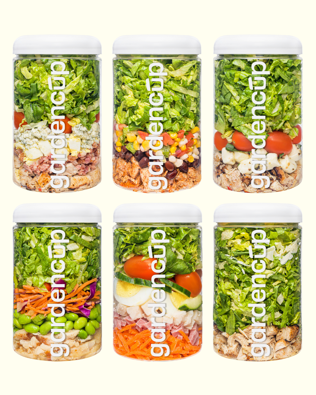 Six jars filled with layered salads, labeled 'gardencup.'