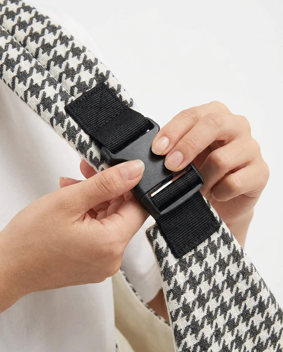 Close-up of parent's hands clicking the buckle closed — simple, confident, one-handed motion