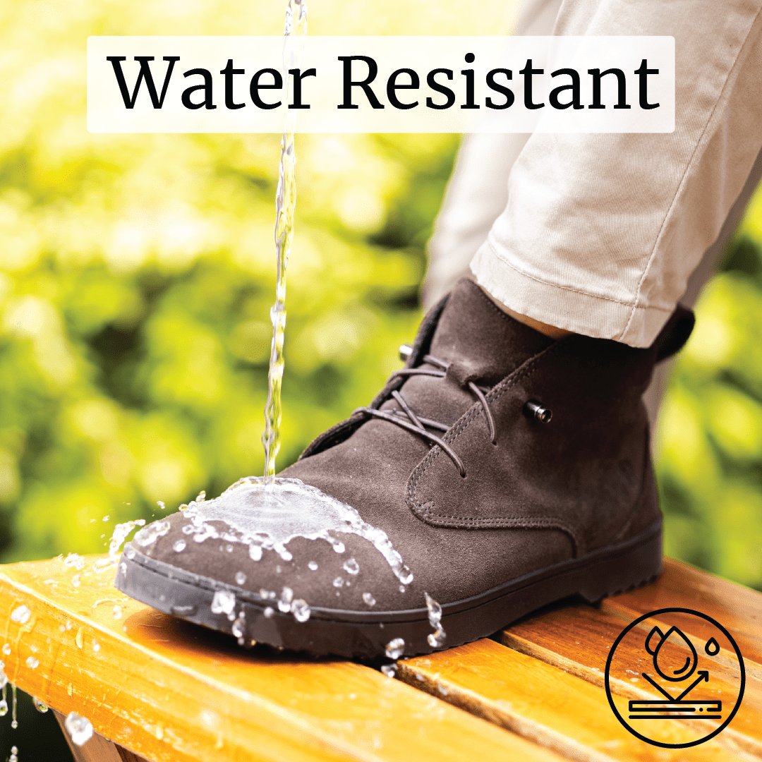 Water pouring over a brown boot labeled 'Water Resistant' on a wooden surface.