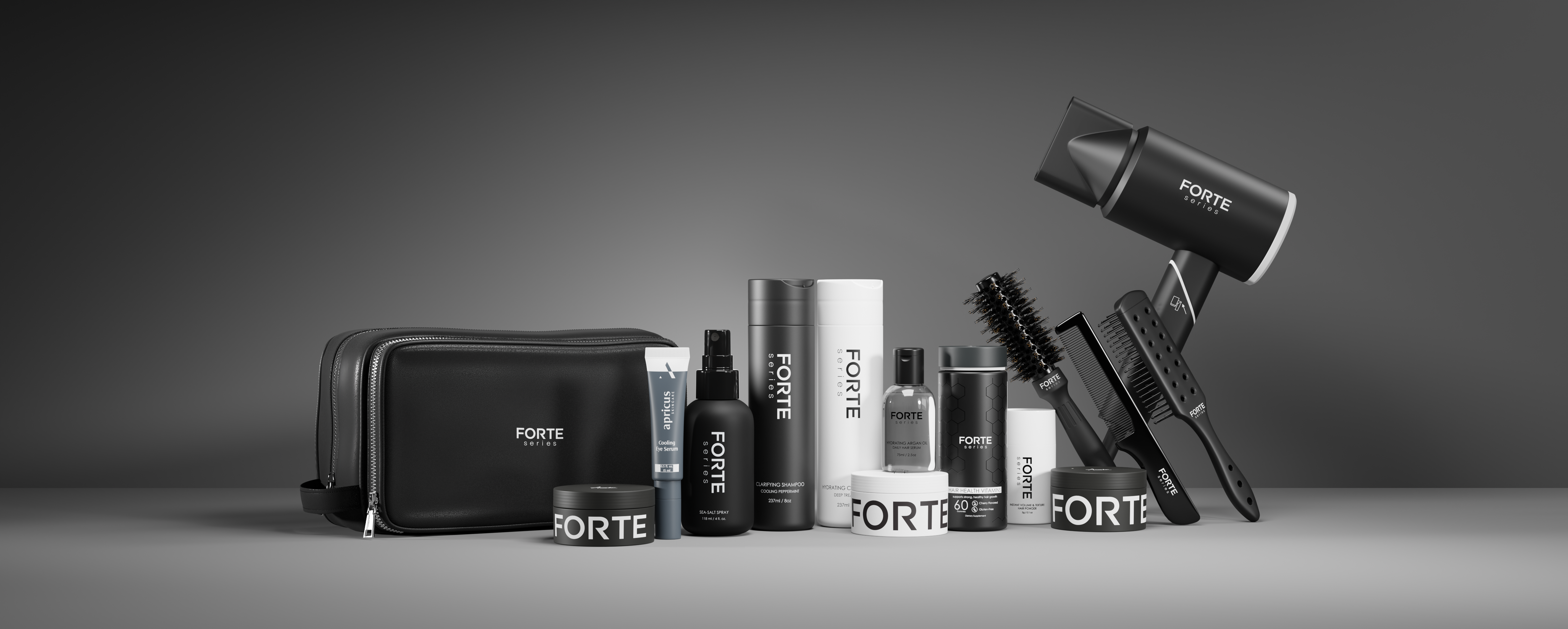 Assorted Forte hair care products and tools on a gray background.