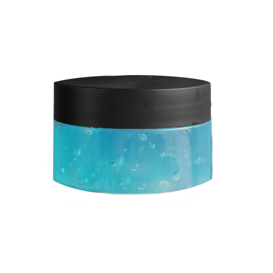 Hand holding a jar with blue gel and black lid.