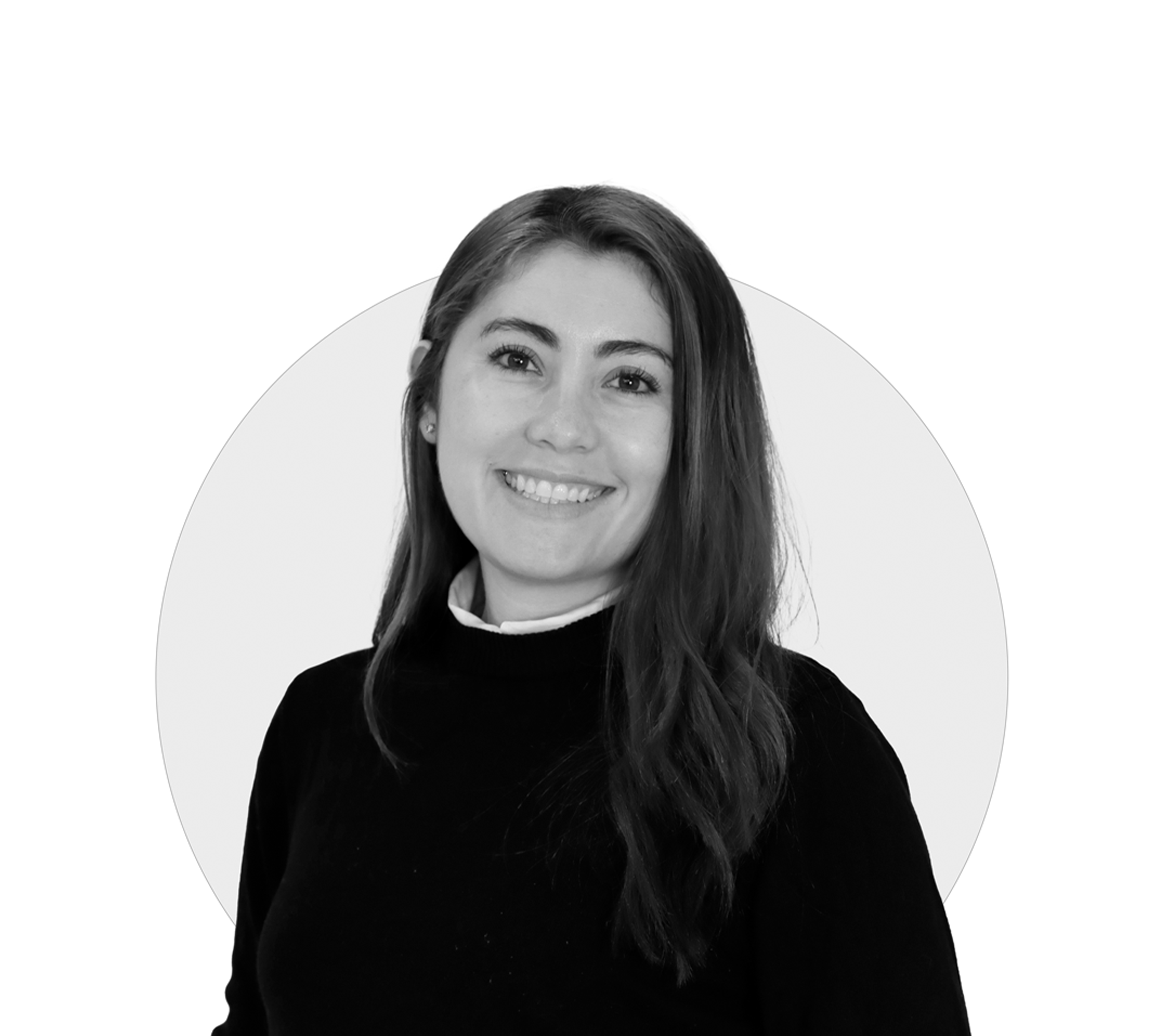 Smiling person in a black sweater against a white background.