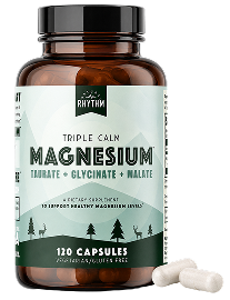 A brown bottle of Rhythm Triple Calm Magnesium supplement with two capsules next to it on a white background.