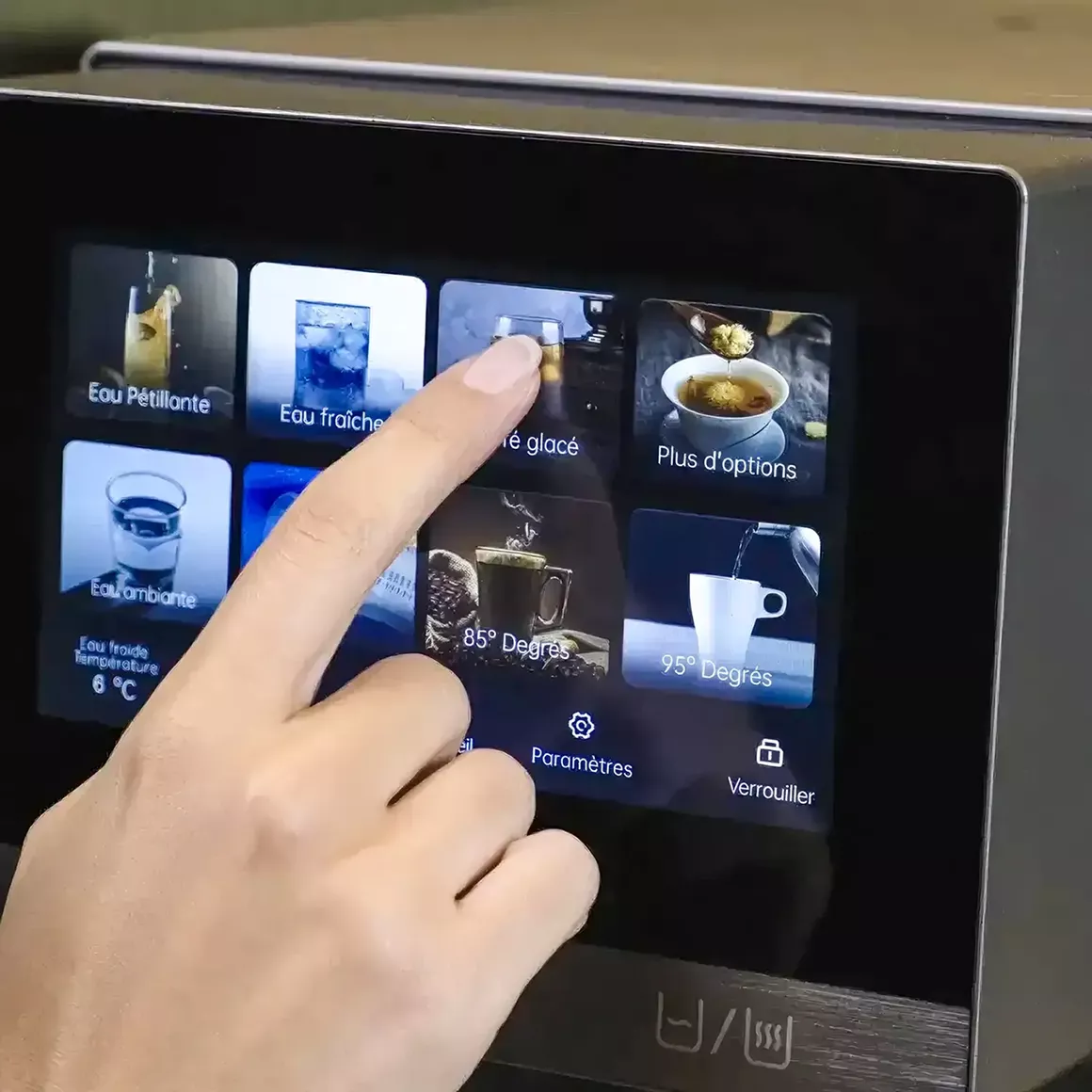 A person uses a finger to select a beverage from a touchscreen interface on a smart water dispenser.