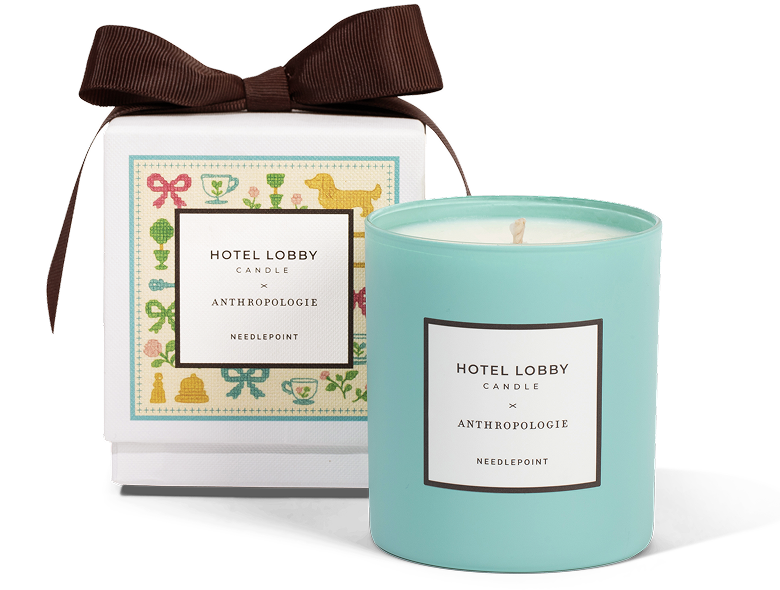 Turquoise candle beside a decorated box with a brown ribbon.