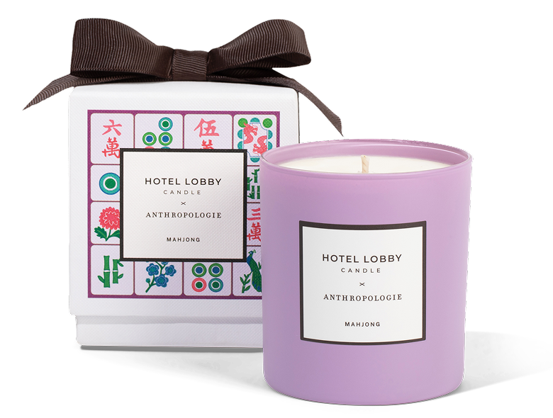 Purple candle and decorated box labeled 'Hotel Lobby Candle x Anthropologie Mahjong.'