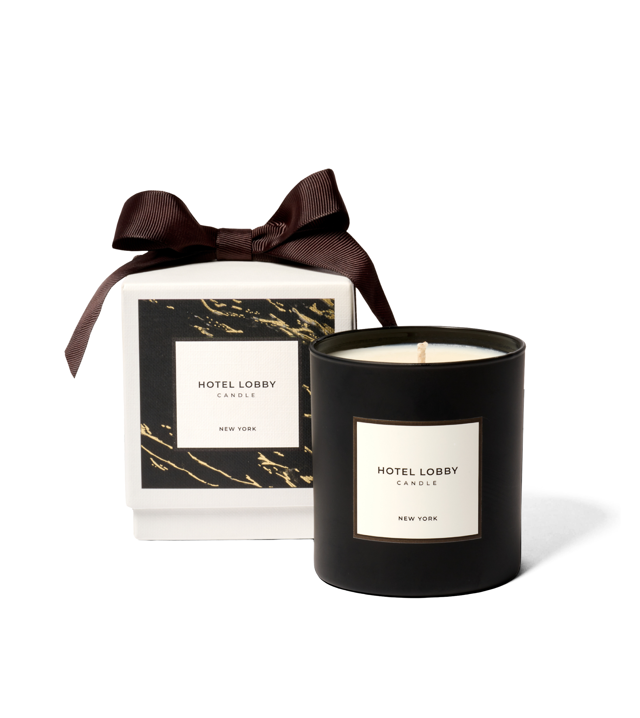 Black candle with 'Hotel Lobby' label next to a matching gift box with a brown ribbon.