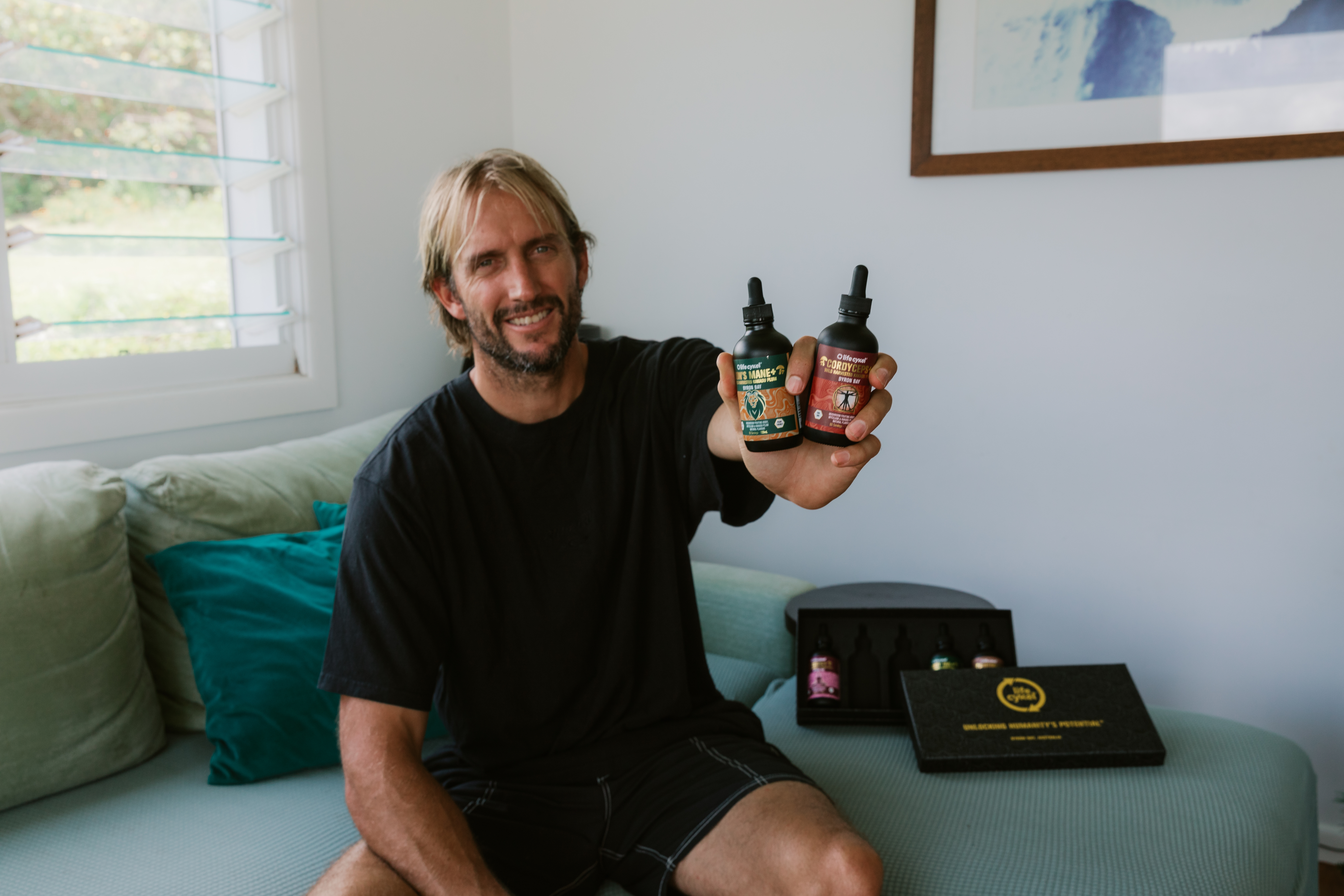 man holding 2 bottles