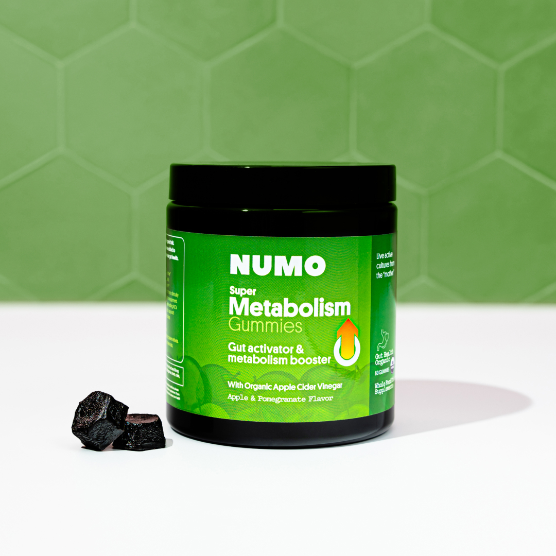 Green jar of NUMO Super Metabolism Gummies on a white surface.