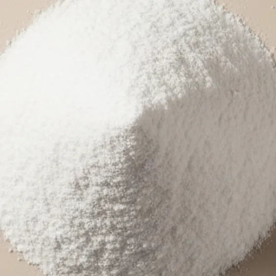 A close-up shot of a pile of fine, white, crystalline powder on a flat surface.