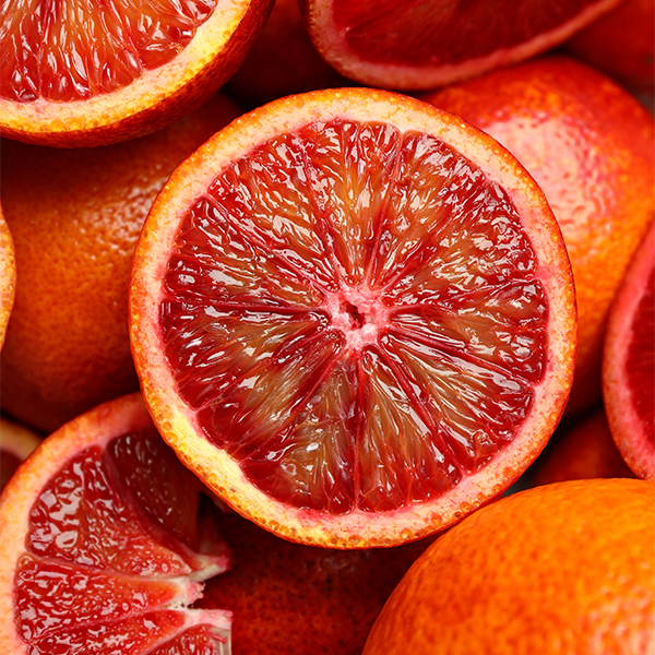 Close-up of sliced blood oranges with vibrant red interiors.