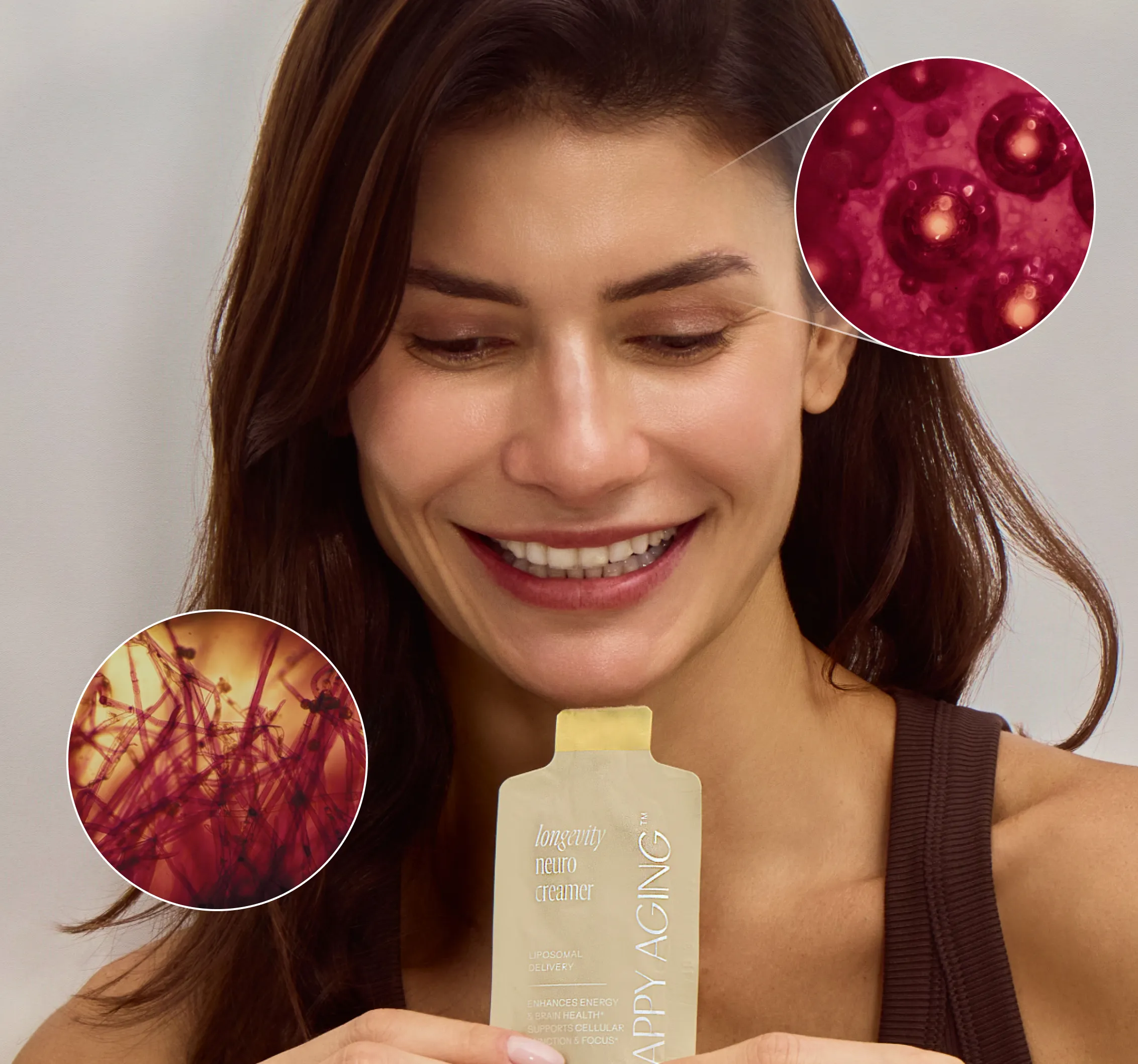 A smiling woman holds a packet of Longevity Neuro Creamer with microscopic images of cells in the background.