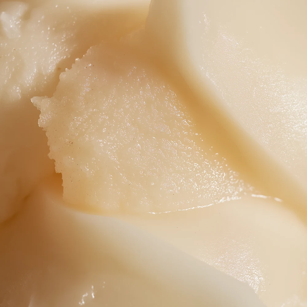 Close-up of a creamy, beige textured surface with smooth and rough areas.