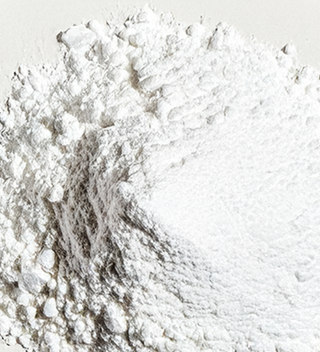 A close-up, overhead shot of a pile of fine white powder against a white background.