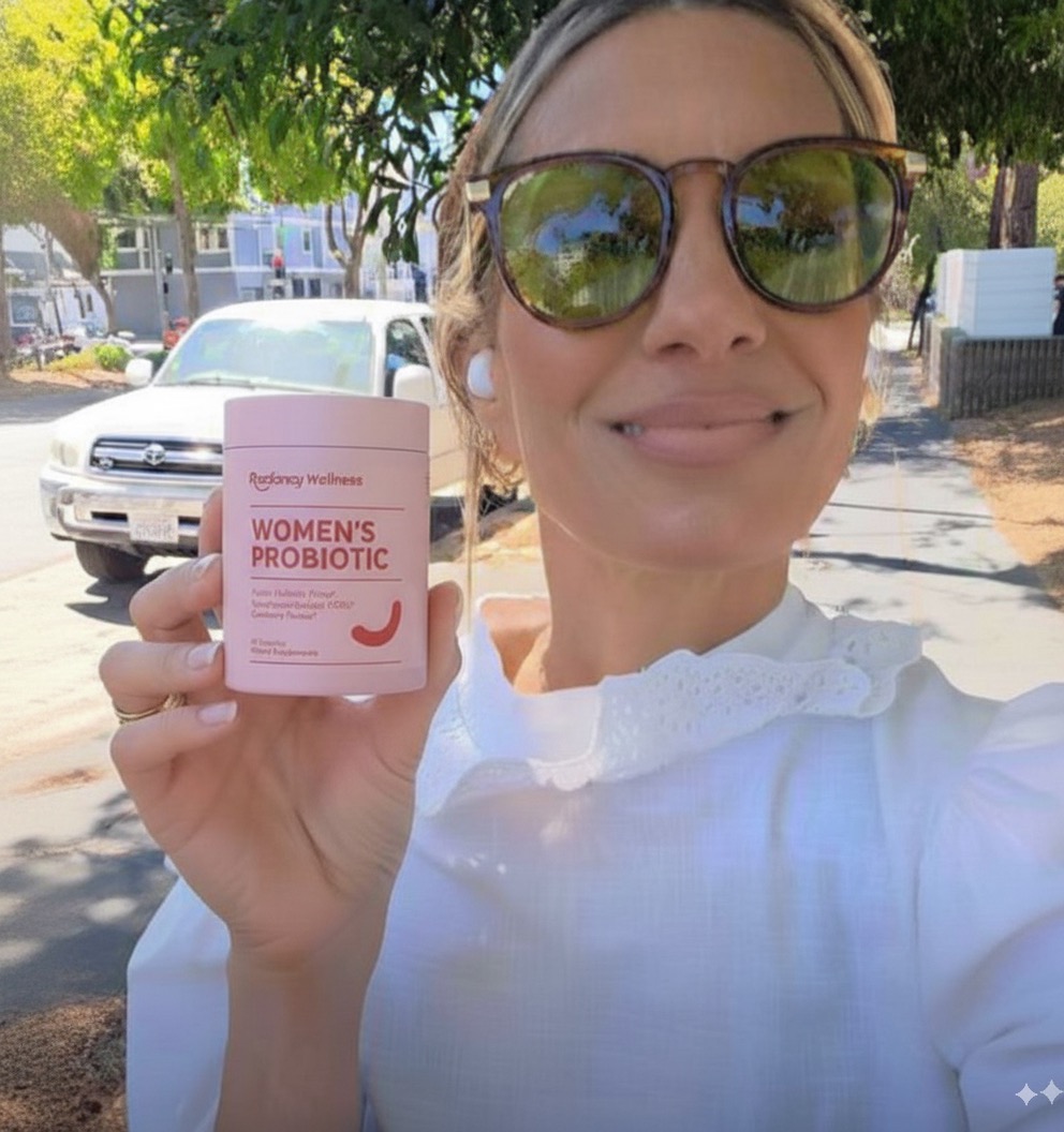 Person outdoors holding a container labeled 'Women's Probiotic'.
