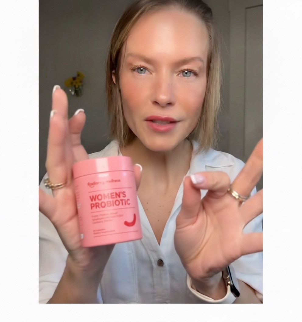 Person holding a pink container labeled 'Women's Probiotic.'