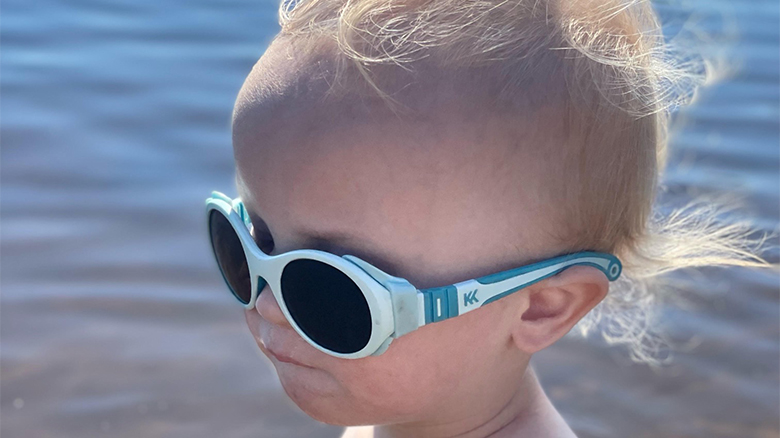 Child wearing Click & Chang sunglasses from Mokki by the water.