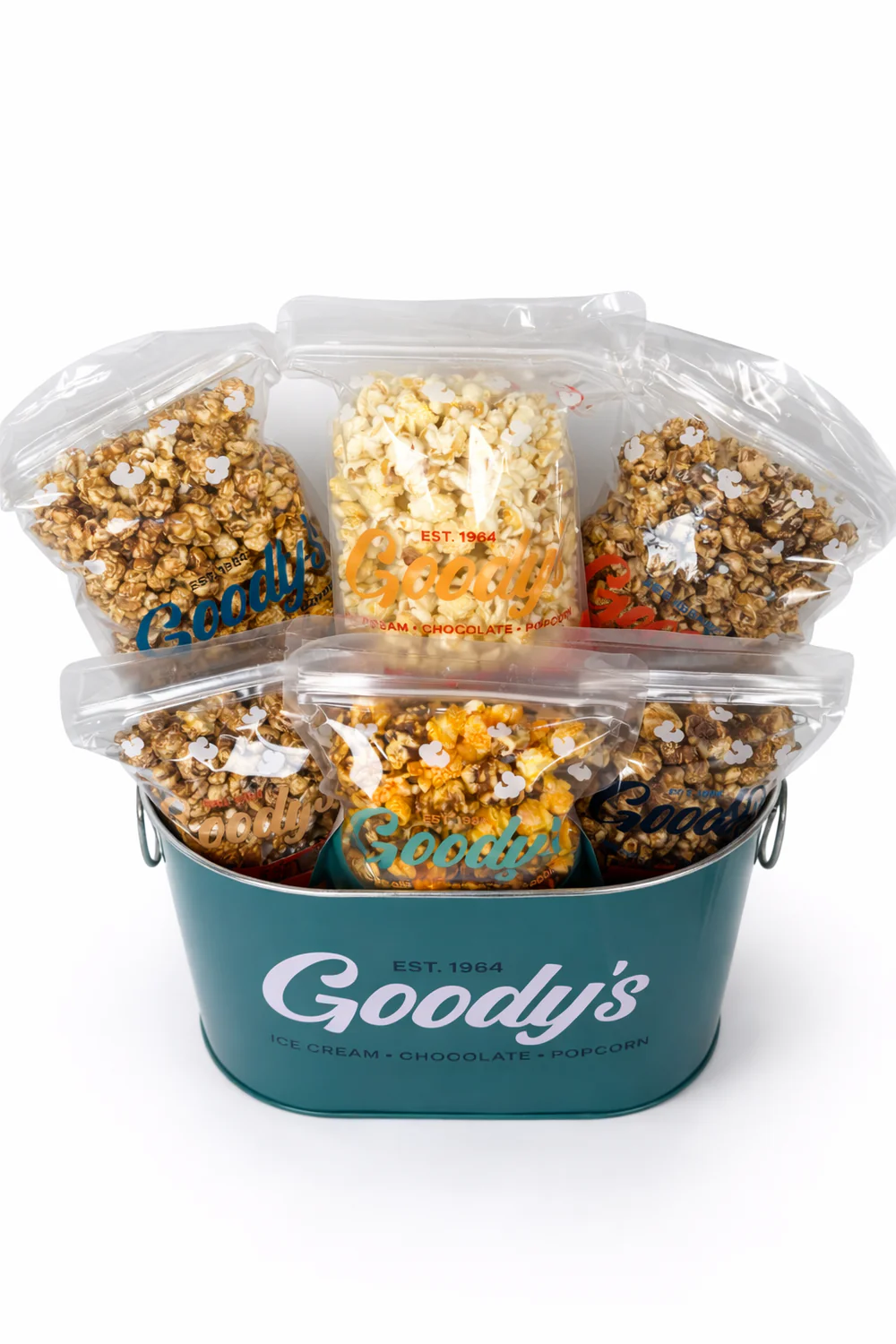 A teal Goody's bucket filled with multiple clear bags of various flavored popcorn.