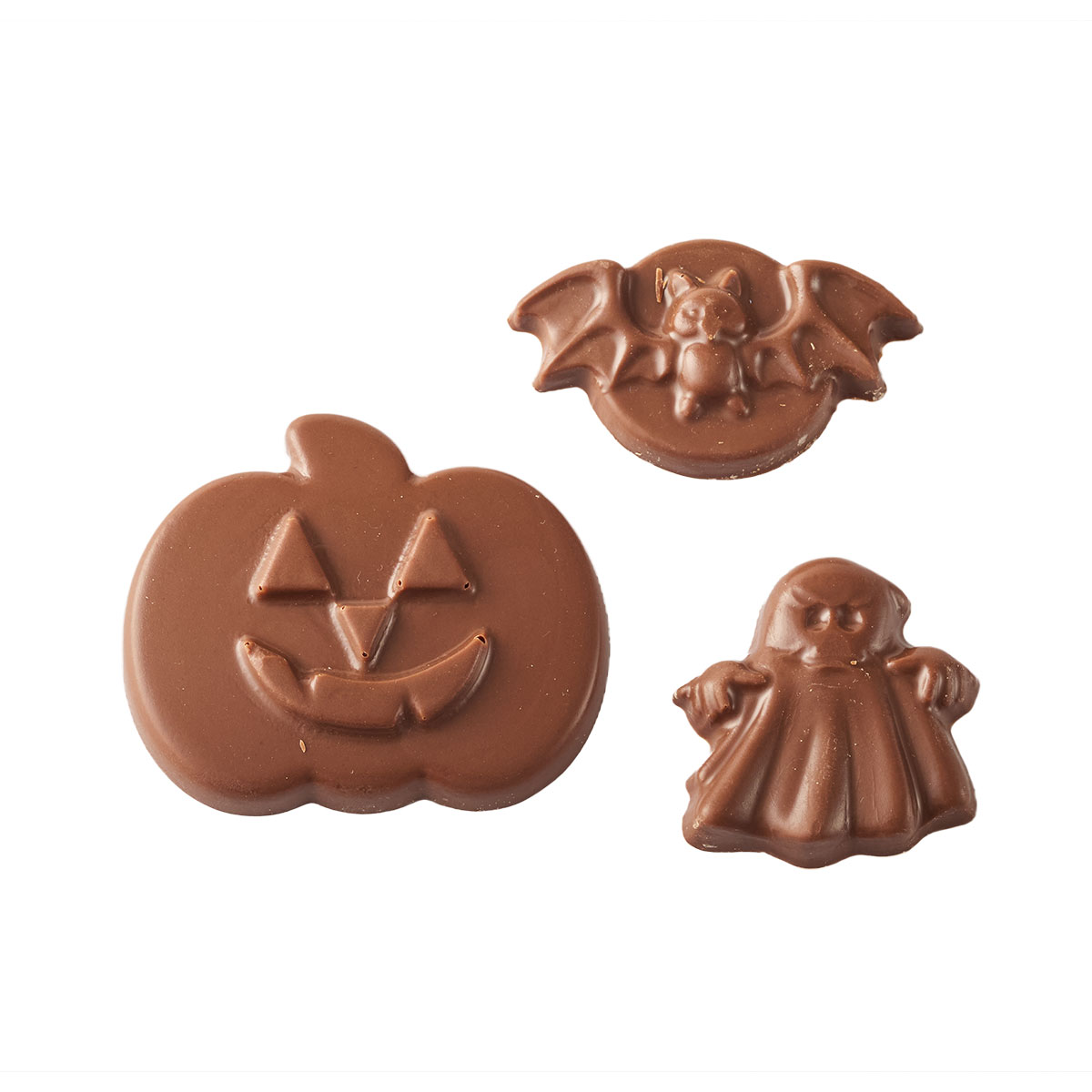 Three chocolates shaped like a pumpkin, ghost, and bat.