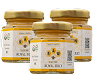 Three small glass jars of Raw Fresh Royal Jelly with gold lids against a white background.