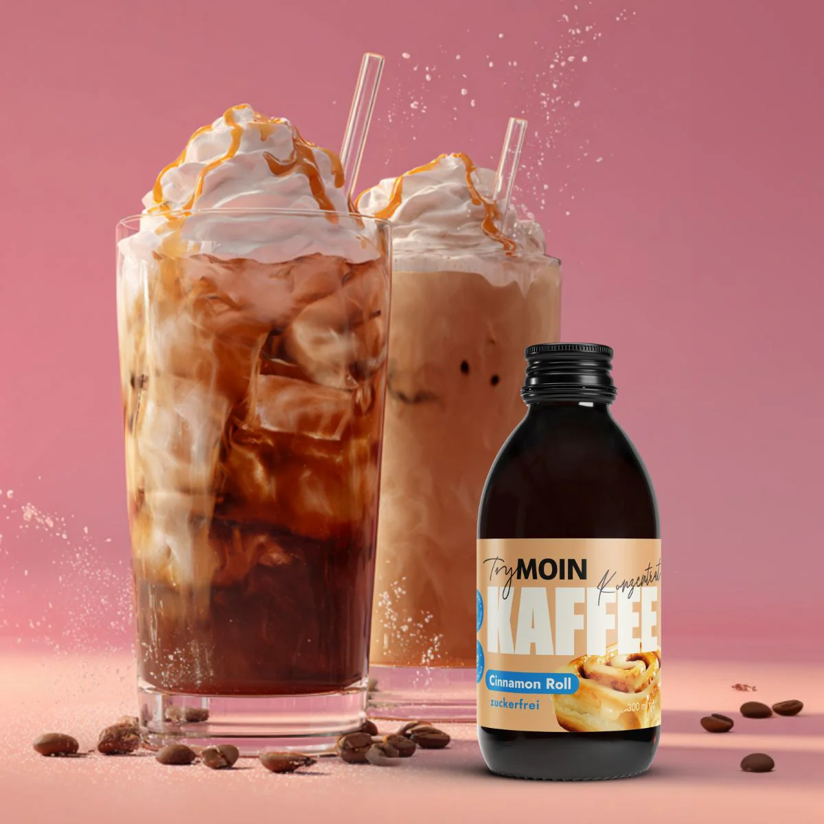 A bottle of TryMOIN Cinnamon Roll coffee concentrate next to two iced coffees with whipped cream.
