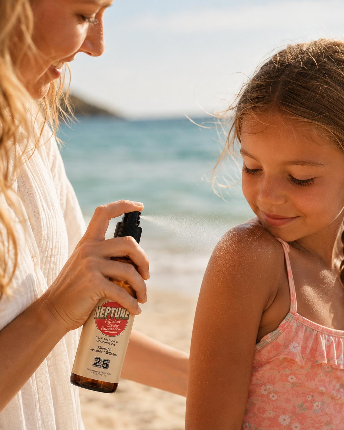 A woman sprays sunscreen on a young girl's shoulder at the beach.