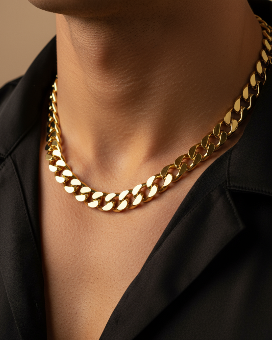 Close-up of a person wearing a gold chain necklace with a black shirt.