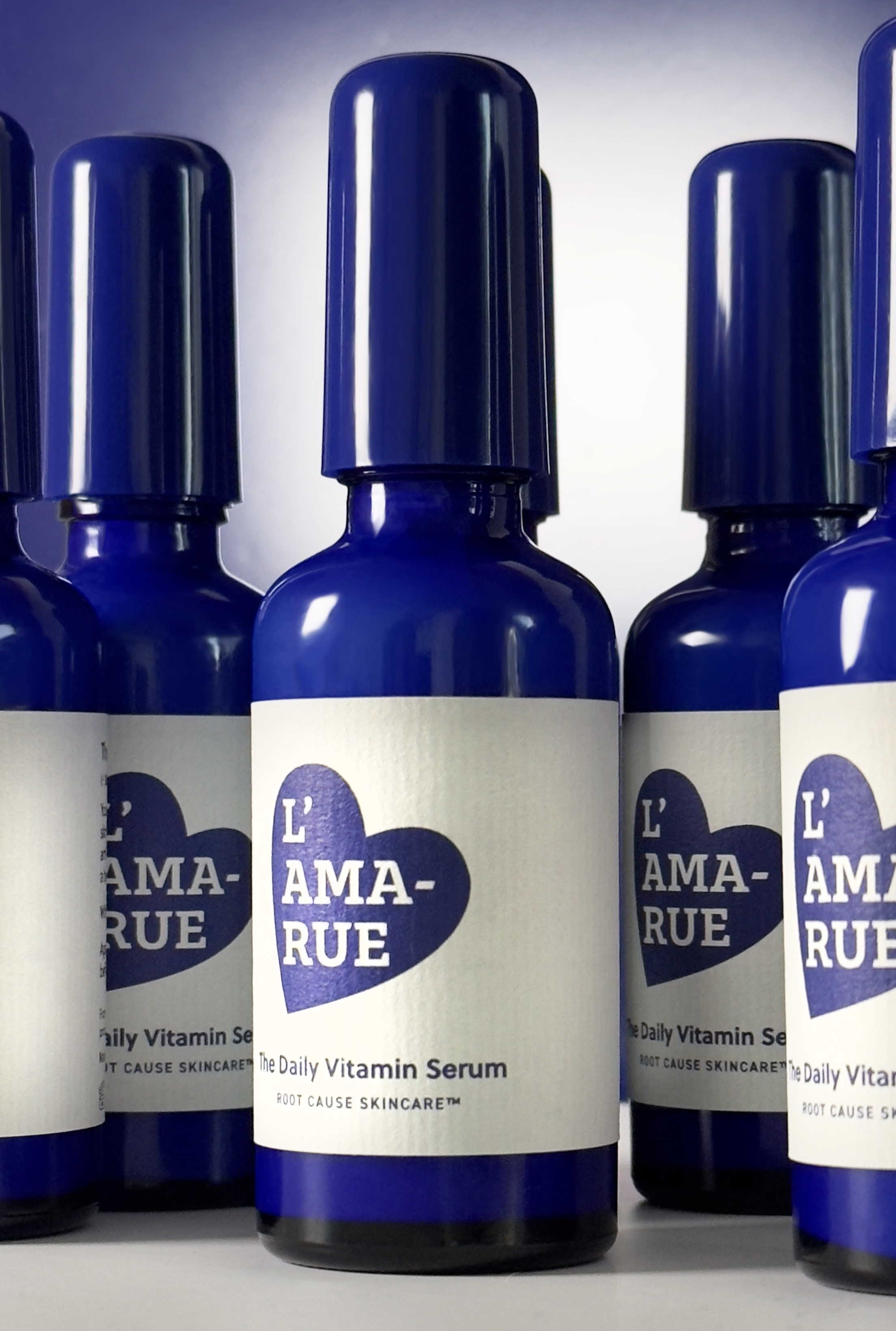 Blue bottles of L'AMARUE Daily Vitamin Serum.