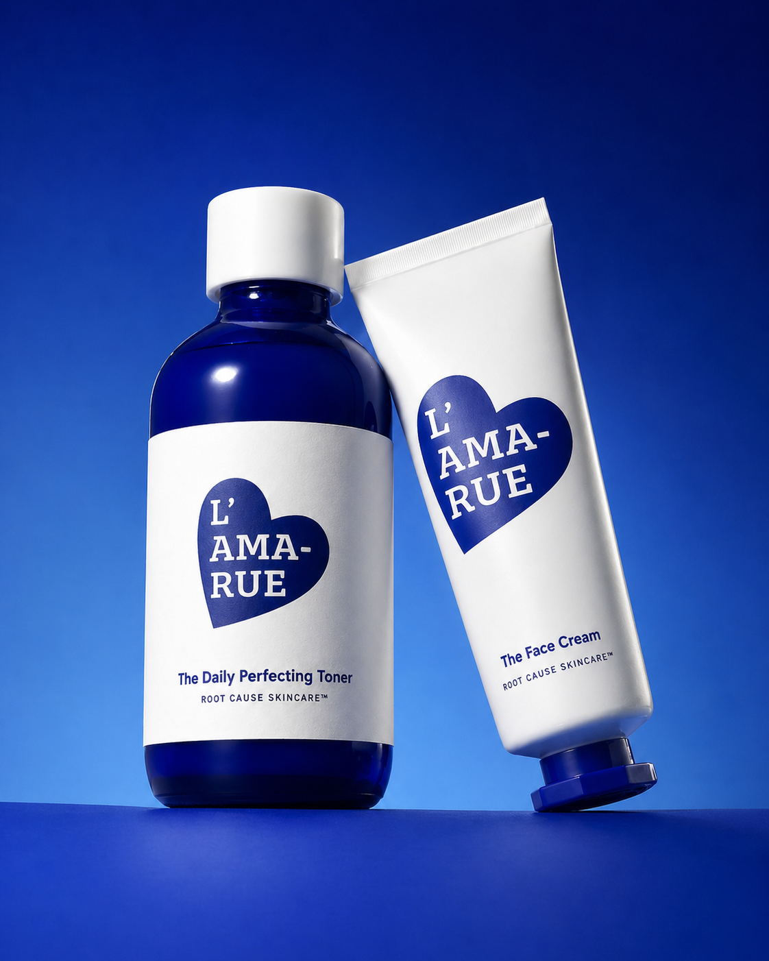 A blue bottle of L'AMA-RUE toner next to a white tube of face cream against a blue background.