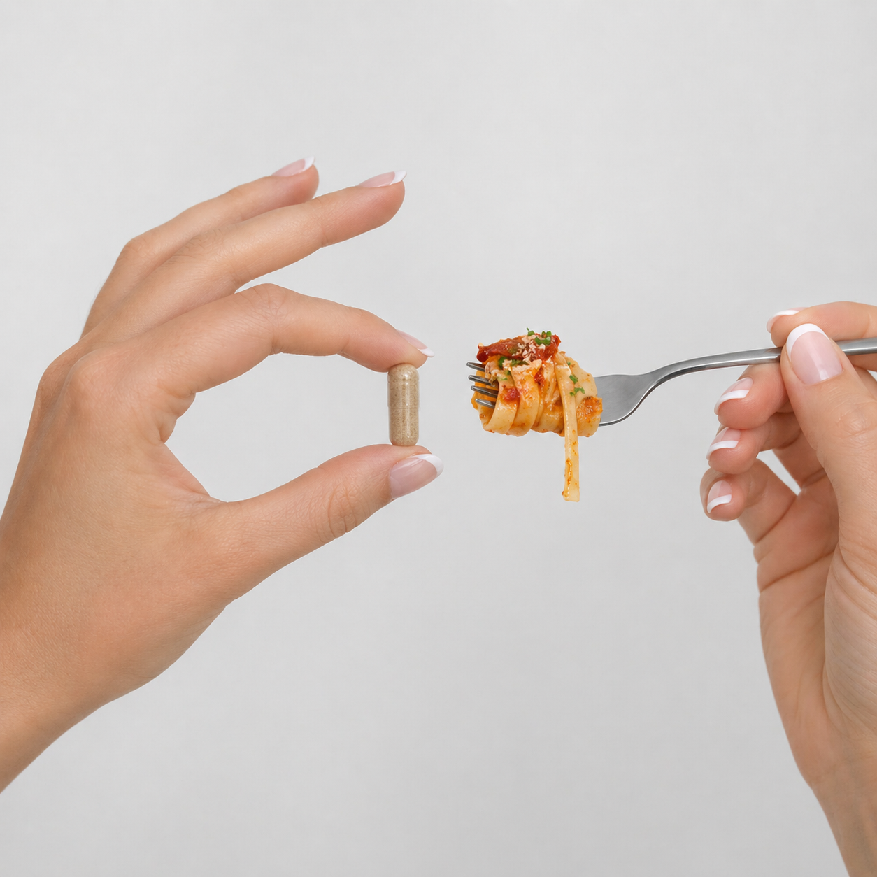 A person holds a supplement capsule in one hand and a fork with a bite of pasta in the other.