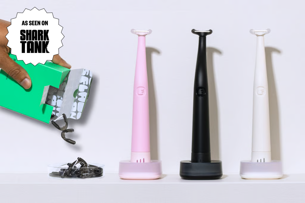 Three tongue scrapers in pink, black, and white, with a hand pouring out refills from a box.