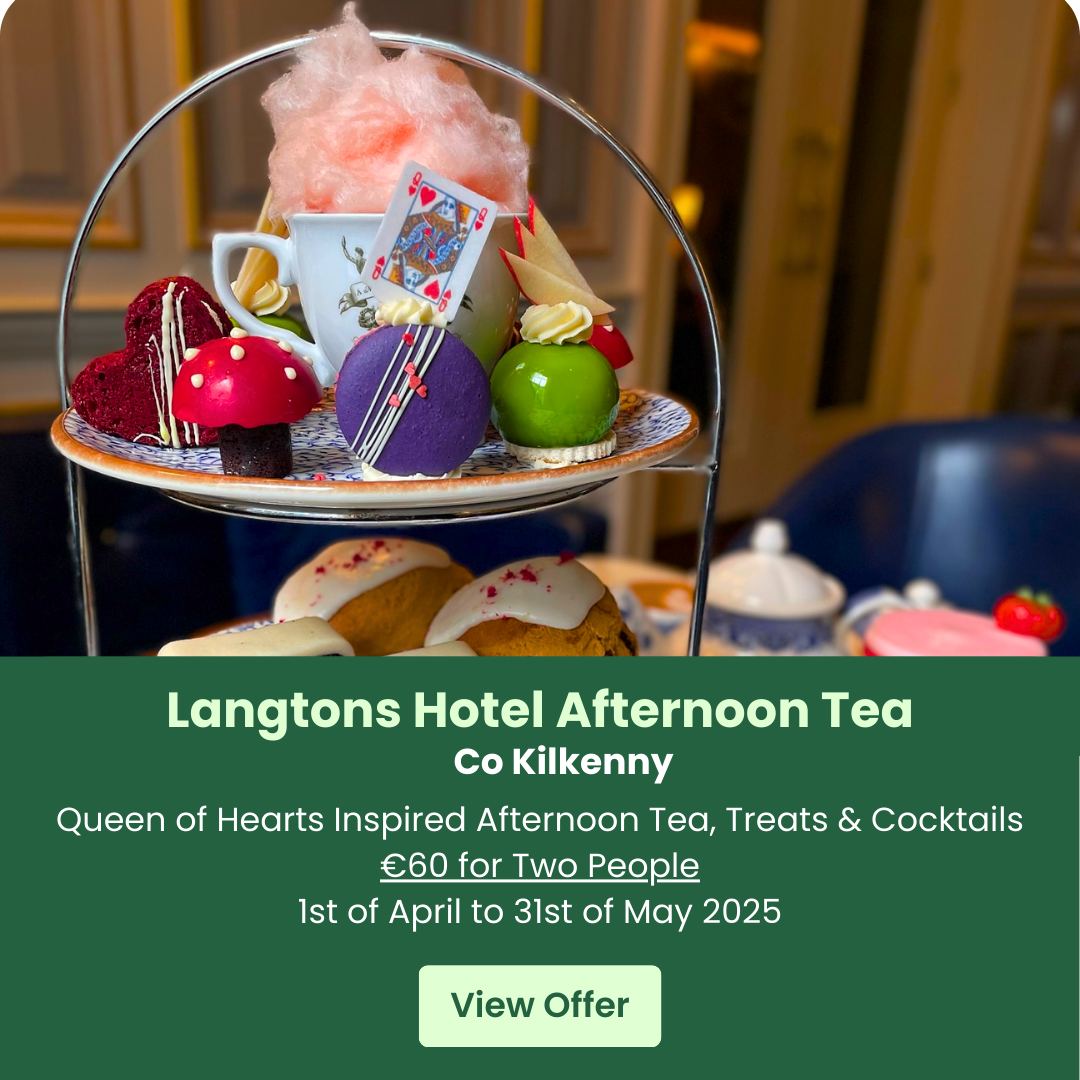 Afternoon tea set with colorful desserts and cotton candy on a tiered stand.