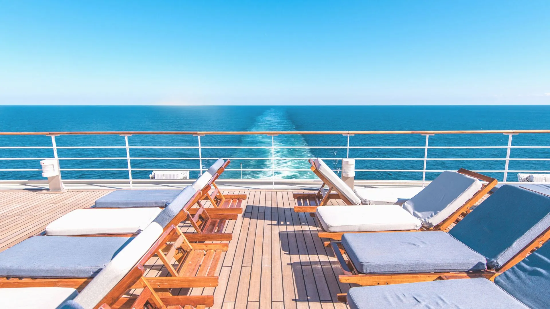 Deck chairs on a cruise ship overlooking the ocean.