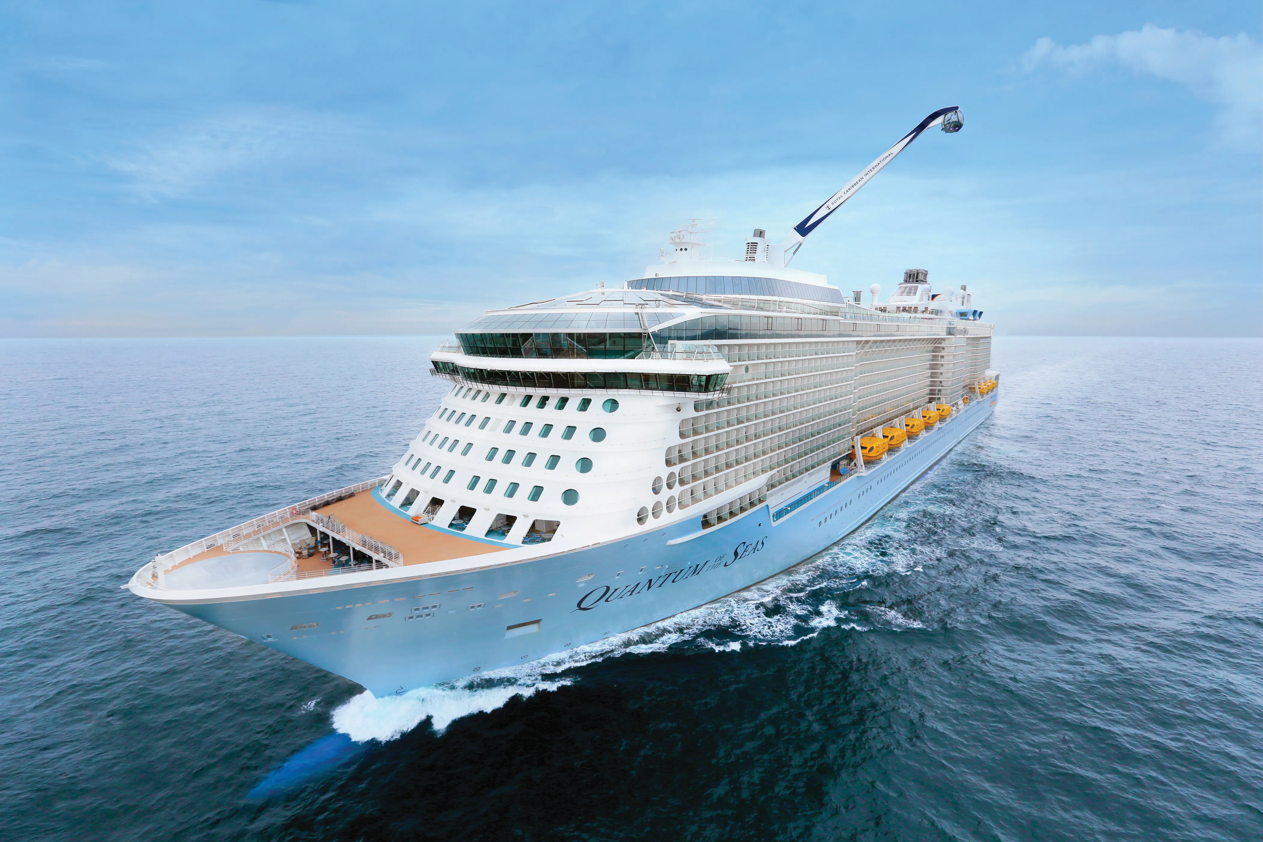 Large cruise ship sailing on the ocean under a clear blue sky.