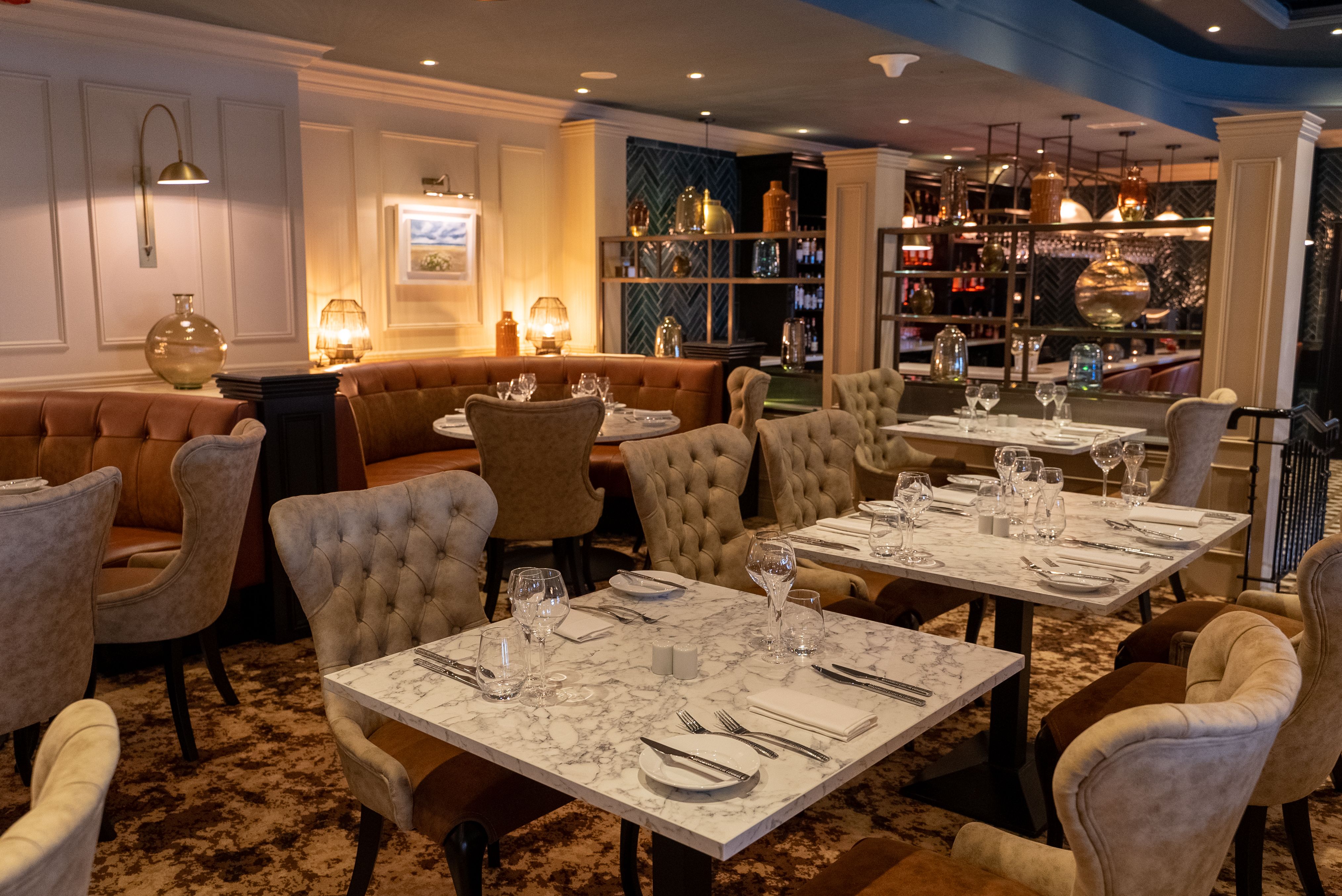 The elegantly decorated interior of a restaurant with tables set for dining.