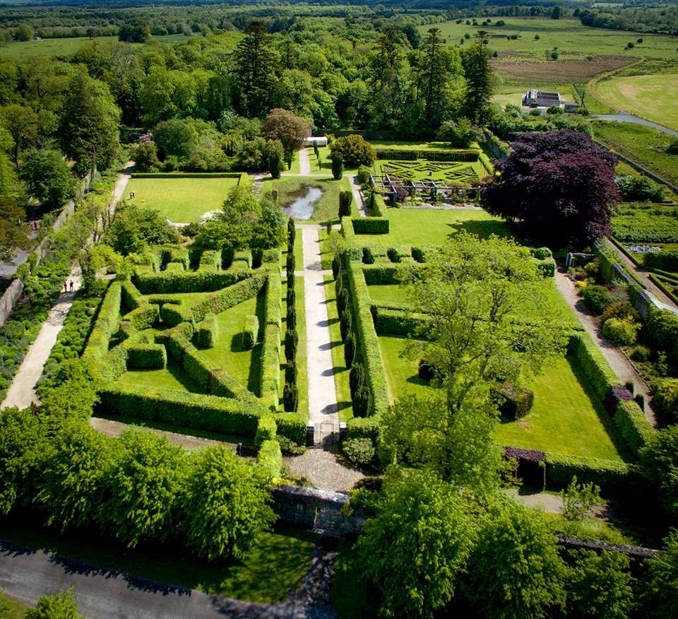 Aerial view of a formal garden with hedges and pathways.