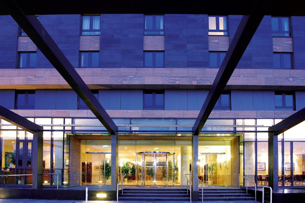 Modern building entrance with glass doors and large windows.