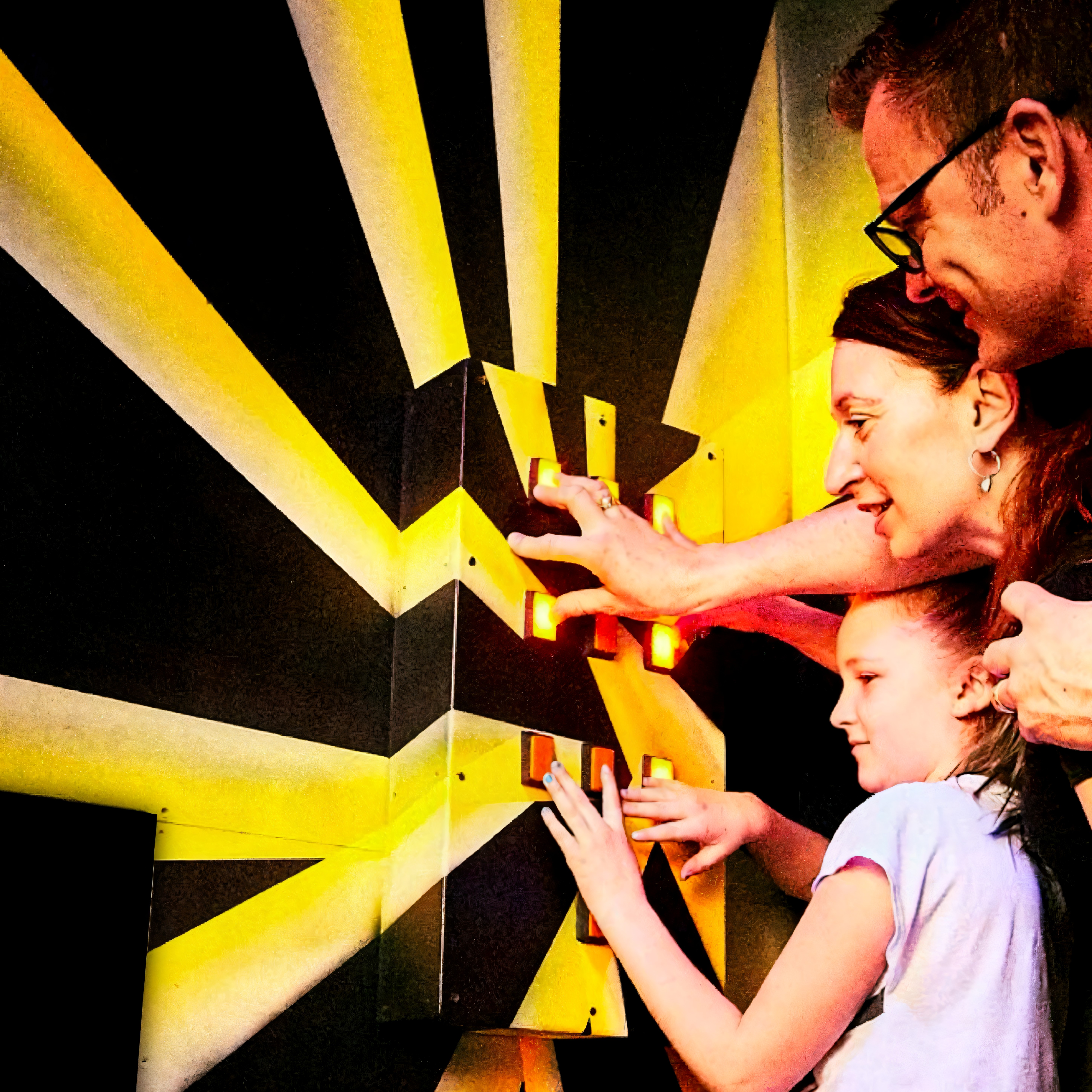 Three people interacting with a wall of illuminated buttons.