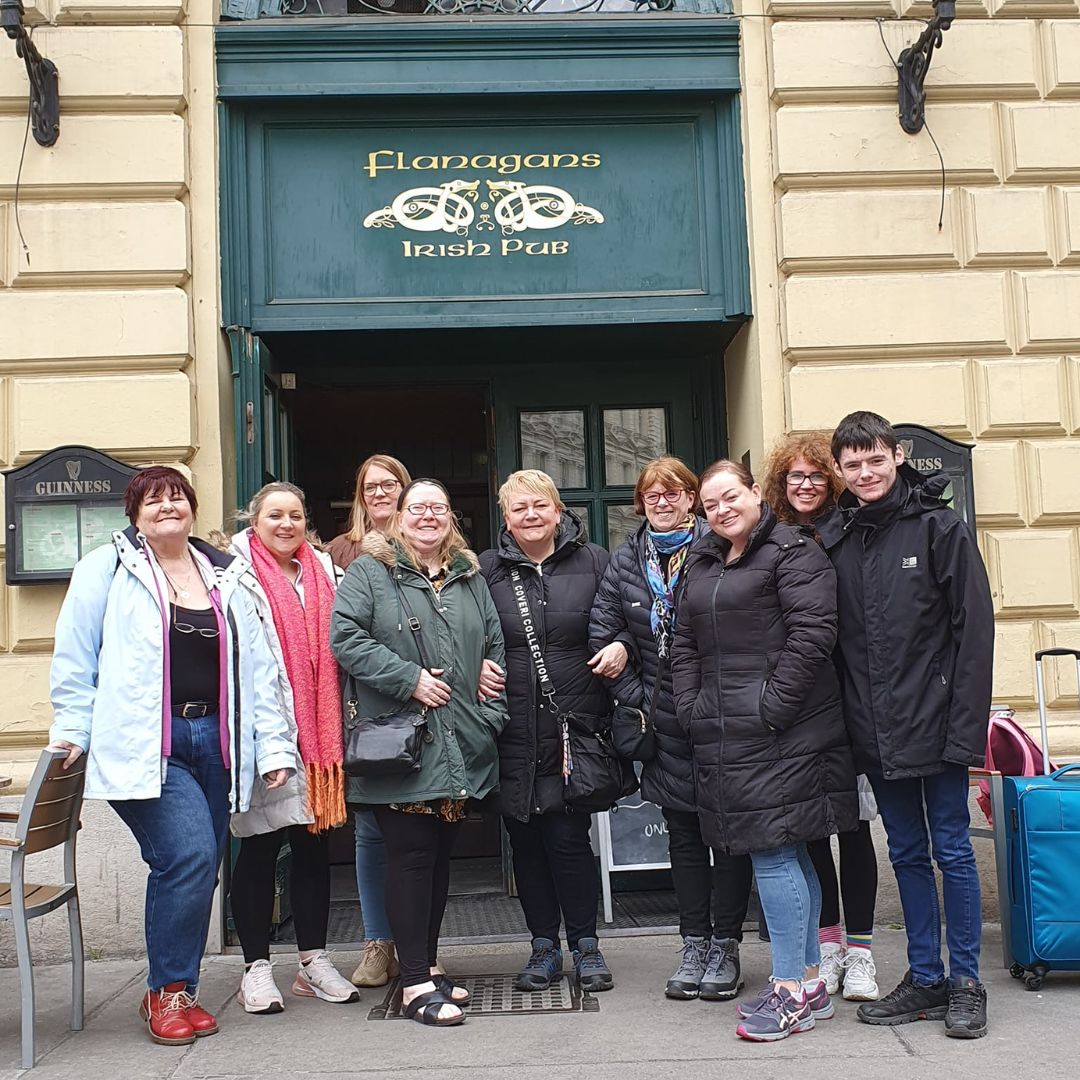 Group of people standing outside Flanagans Irish Pub.