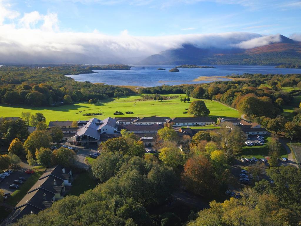 Aerial view of a lakeside resort surrounded by trees and mountains.