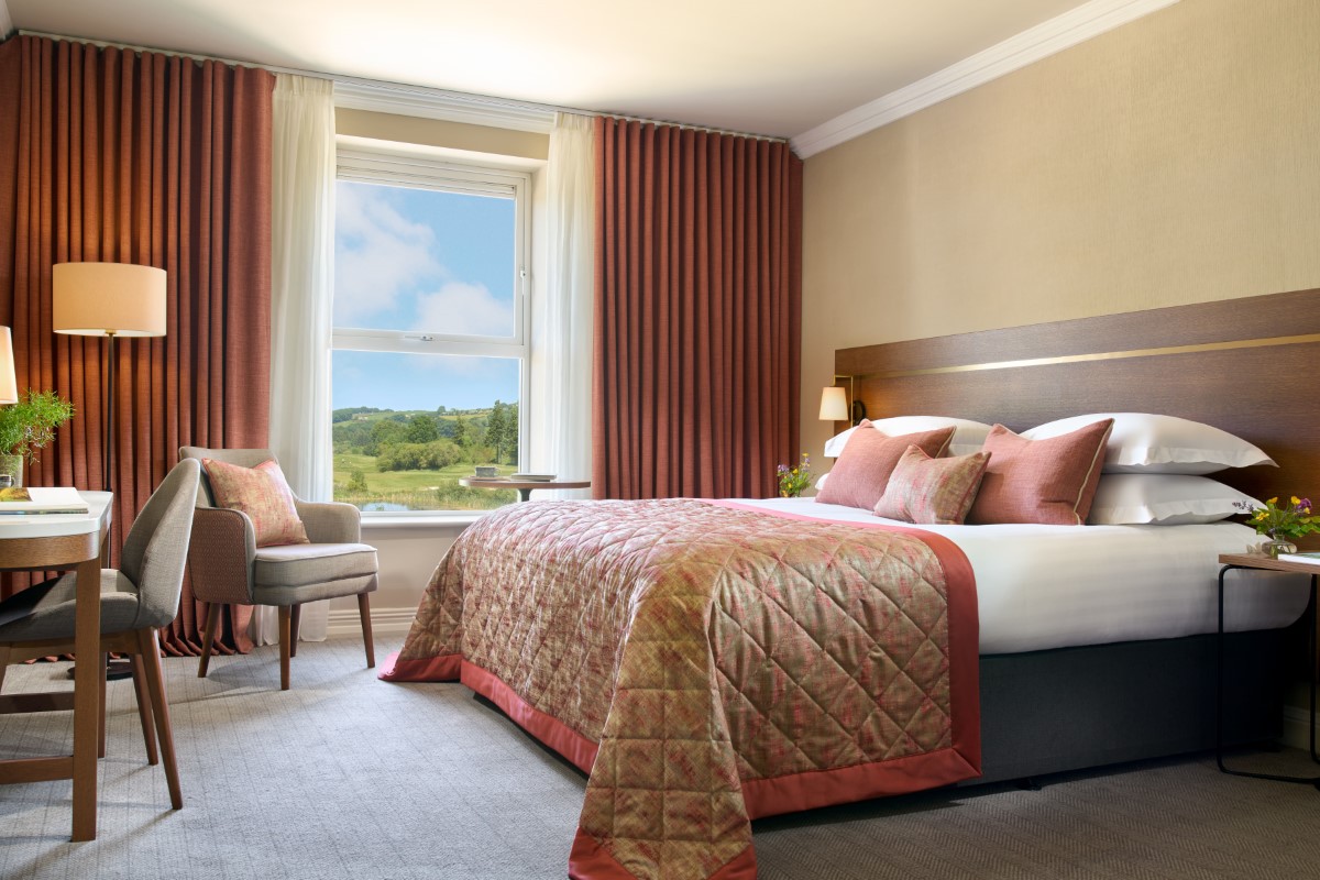 Hotel room with two neatly made beds and modern decor.