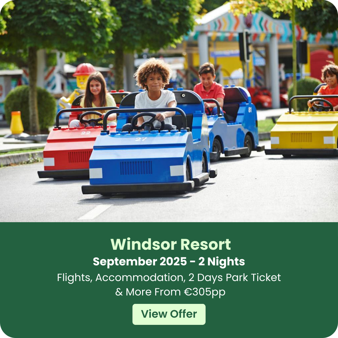 Children driving colorful toy cars at an amusement park.